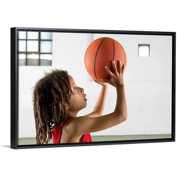 "Boy aiming a shot with a basketball in a school sports hall." Black Float Frame Canvas Art